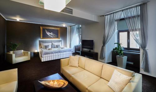 a living room with a couch and a bed at Boutique Hotel Chrysso in Košice