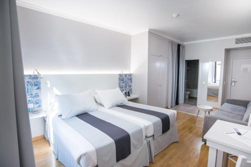 a bedroom with a bed and a living room at Sé Boutique Hotel in Funchal