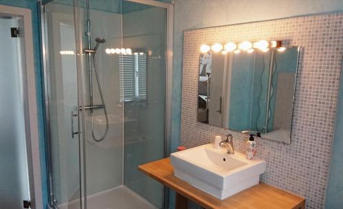 a bathroom with a sink and a shower at Logies Zen aan Zee in Ostend