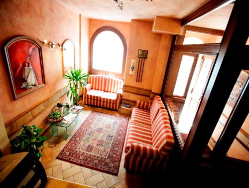 a living room with a couch and a window at Hotel Ristorante Garibaldi in Frosinone