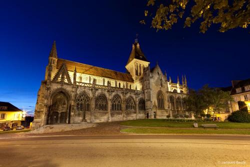 a large building with a cathedral at night at ibis Falaise Coeur de Normandie in Falaise