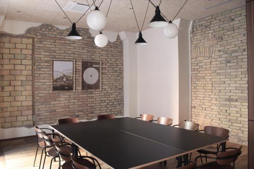 a conference room with a black table and chairs at c-hotels Fiume in Rome