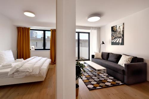 a living room with a couch and a bed in it at Smart & Green Living by Ambiente in Bratislava
