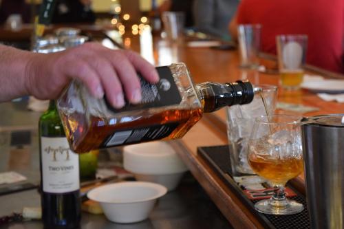 a person pouring a bottle of wine into a glass at North Star Lodge & Resort in Killington