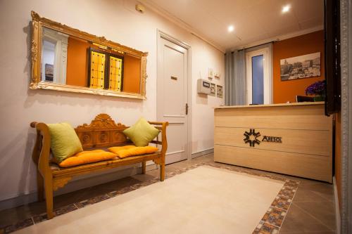 a dressing room with a bench and a mirror at Hostal Aresol in Madrid