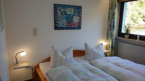 a bedroom with a bed and a window at Ferienwohnung an der Almequelle in Alme