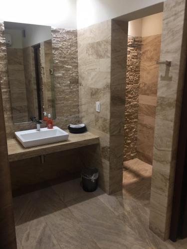 a bathroom with a sink and a mirror at Amazing Vista Coral Condo in La Paz