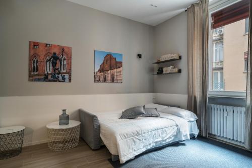 a bedroom with a bed and a window at San Petronio Central Studio in Bologna
