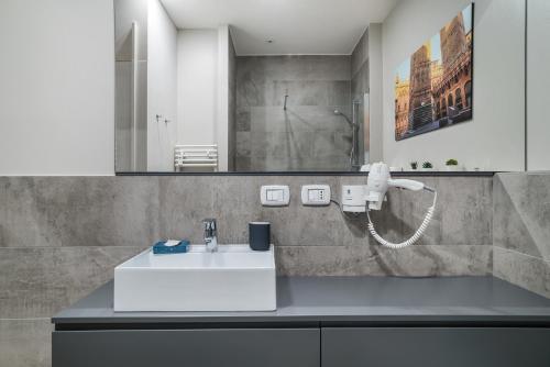 a bathroom with a white sink and a mirror at San Petronio Central Studio in Bologna
