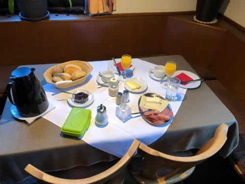 a table with food and drinks and bread on it at Zum waldfrieden in Neuhof