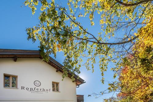 a building with a clock on the side of it at Ropferhof in Telfs-Buchen