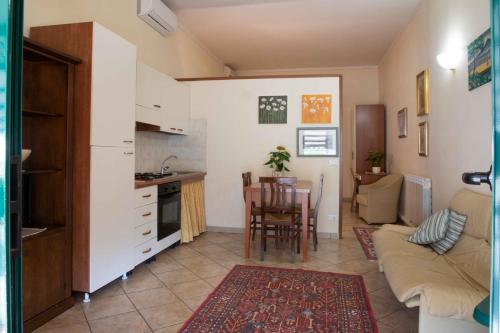 a kitchen and living room with a couch and a table at Al Frantoio Maddii Levane bed and breakfast in Levane