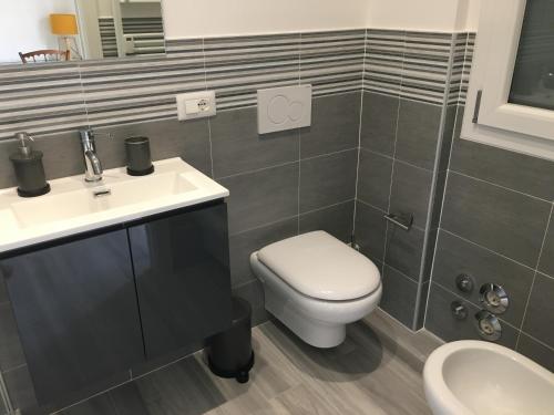 a bathroom with a toilet and a sink at Four Rooms in Bologna