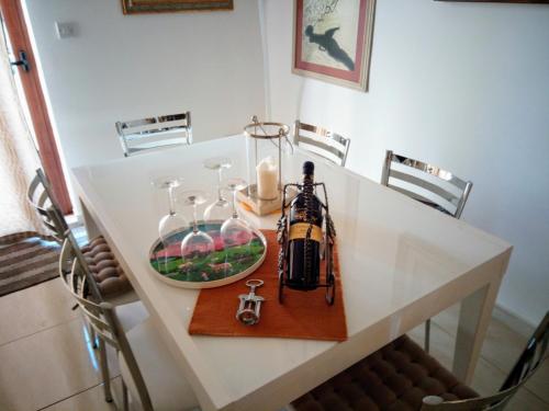 a table with a candle and glasses on it at Gianni Holiday Home in Pieta