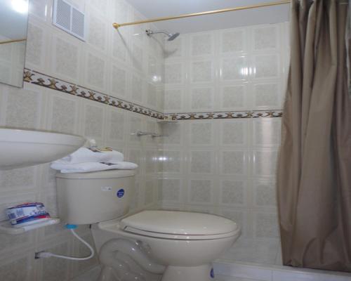 a bathroom with a toilet and a shower at Hotel Casa Sabelle in Bogotá