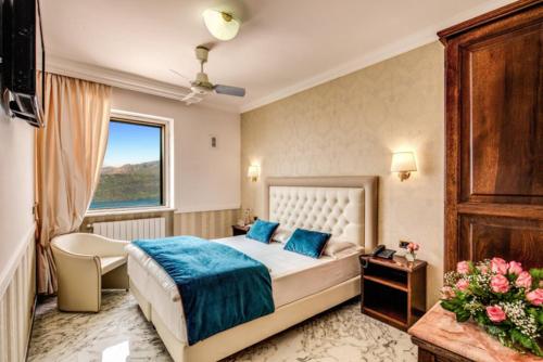 a hotel room with a bed and a window at Hotel Castel Vecchio in Castel Gandolfo