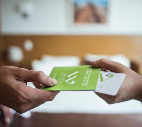 a person holding a playing card in their hands at Weston Suites Hotel in Santo Domingo