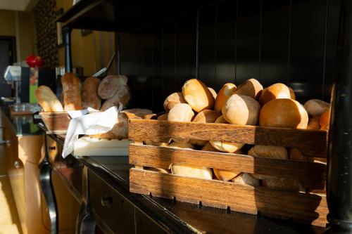 a bunch of loaves of bread in baskets on a counter at Mediterranean Princess- Adults Only in Paralia Katerinis