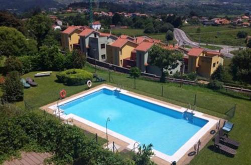 an image of a swimming pool in a yard with houses at La Casa de Leo " only adults " in Muros de Nalón