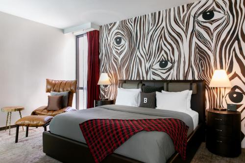 a bedroom with a bed with a zebra print wall at Bobby Hotel in Nashville
