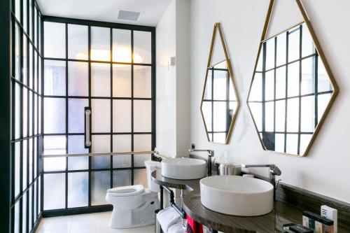 two sinks in a bathroom with large windows at Bobby Hotel in Nashville