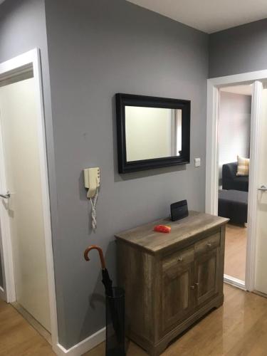 a room with a mirror and a wooden box on a wall at Elegant Apartment Near SECC/HYDRO in Finnieston, Glasgow in Glasgow