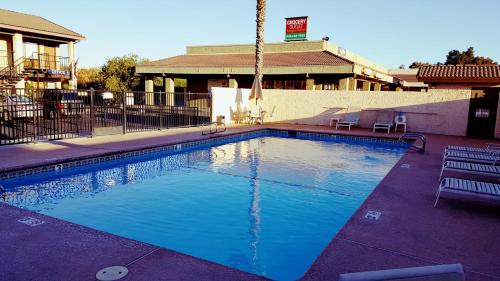 a large pool with blue water in front of a building at Orland Inn in Orland