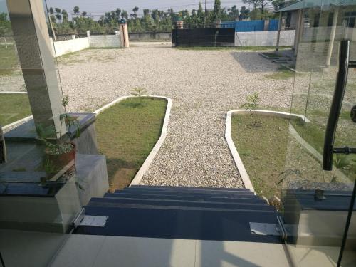 a view of a yard from a glass door at Hotel hornbill in Sauraha