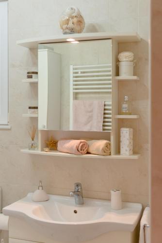 a bathroom with a sink and a mirror at Ivkolina in Hvar