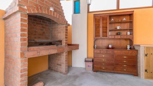 a brick oven in a room with a dresser at APARTMAN ŠARE in Crikvenica