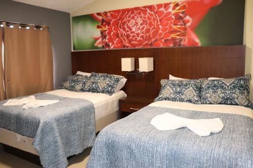 a hotel room with two beds with bows on them at Jaco Sol Quadplex 11A in Jacó