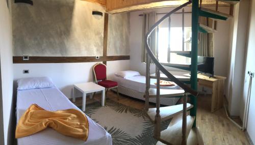 a room with two bunk beds and a ladder at Shkreli Resort Qafeshtame in Krujë