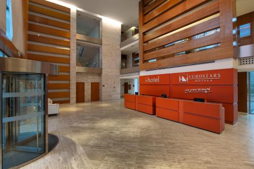 a lobby with orange dividers in a building at Eurostars i-hotel Madrid in Pozuelo de Alarcón