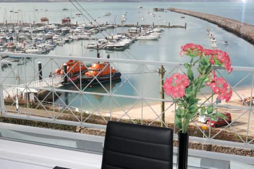 a window with a view of a marina with boats at Devoncourt Devoncoast SeaView Apartments in Brixham