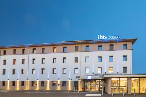 a large white building with a sign on it at ibis budget Rennes Rte Lorient in Rennes