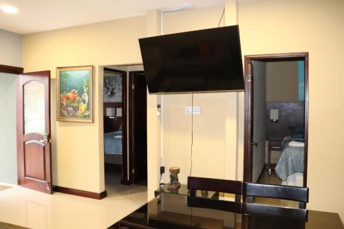 a living room with a flat screen tv on the wall at 11B Jaco Sol Quadplex in Jacó