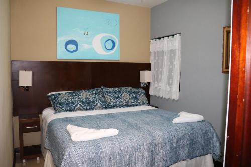 a bedroom with a bed with two towels on it at 11B Jaco Sol Quadplex in Jacó