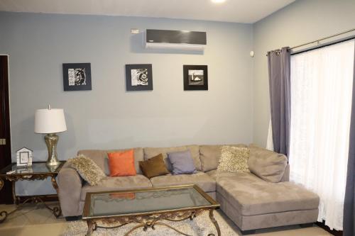 a living room with a couch and a table at 11B Jaco Sol Quadplex in Jacó