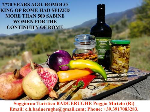 a plate of fruits and vegetables and a bottle of wine at Baduerughe - ValledelLago in Poggio Mirteto