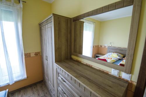 a bedroom with a large mirror and a bed at Villa Gracia Podhájska in Podhájska