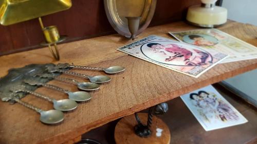 a wooden table with spoons and pictures on it at DoubleTree House in Chiang Mai