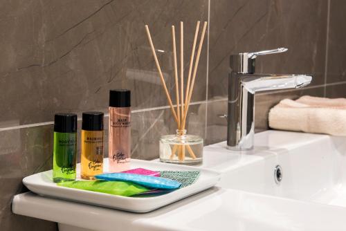 a bathroom counter with two bottles ofodorizers and a sink at Residenza Venti Settembre in Rome