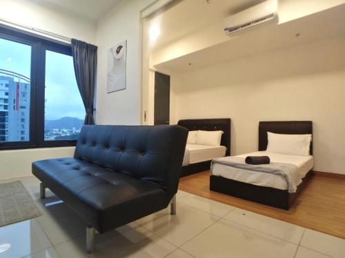 a bedroom with a couch and a bed and a chair at Georgetown City View Condo Tropicana 218 Macalister in George Town