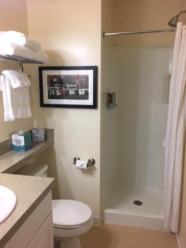 a bathroom with a shower and a toilet and a sink at Washington Plaza - Portland in Portland