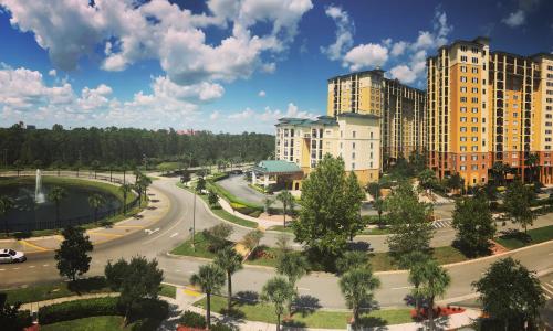 an empty street in a city with tall buildings at Lake Buena Vista Resort Village and Spa, Near Disney in Orlando