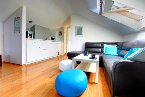a living room with a couch and a table at Beachfront Apartment. 2xAC & BIKES in Postira
