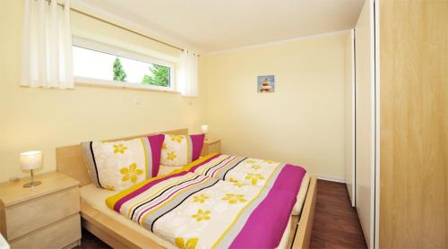 a bedroom with a large bed with a window at Bergoase Panorama-Apartments in Kirnitzschtal