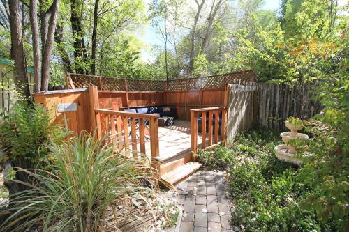 a wooden walkway in a garden with a fence at Dreamcatcher B&B in Taos