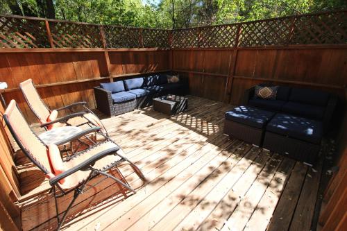 a deck with a couch and a chair and a couch at Dreamcatcher B&B in Taos