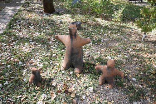 a group of statues sitting in the grass at Dreamcatcher B&B in Taos